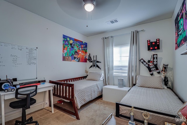 bedroom featuring visible vents and light carpet