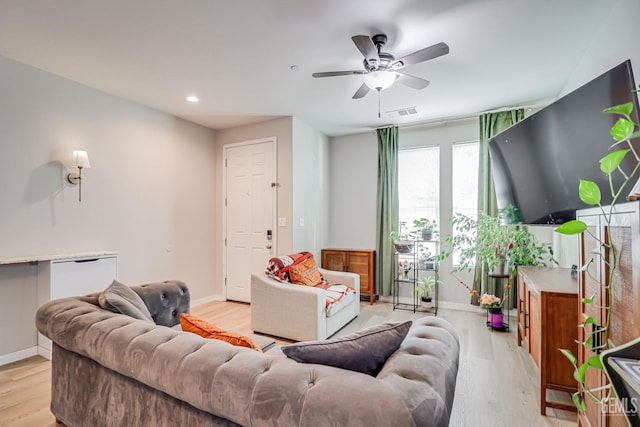 living room with recessed lighting, baseboards, a ceiling fan, and light wood finished floors