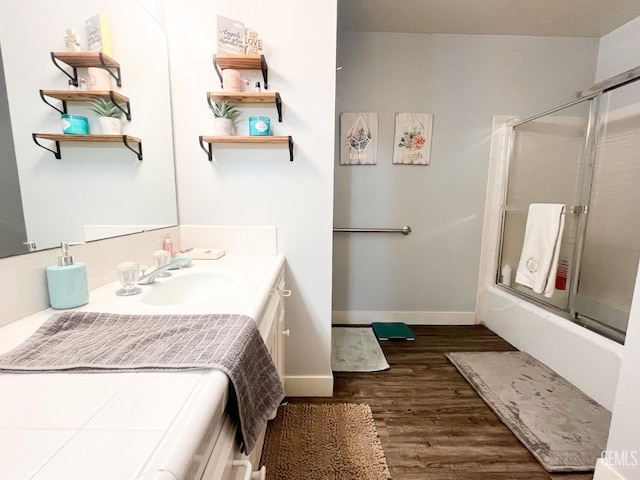 5421 Demaret Ave, Bakersfield, CA 93309 - full bathroom with vanity, wood finished floors, and enclosed tub / shower combo