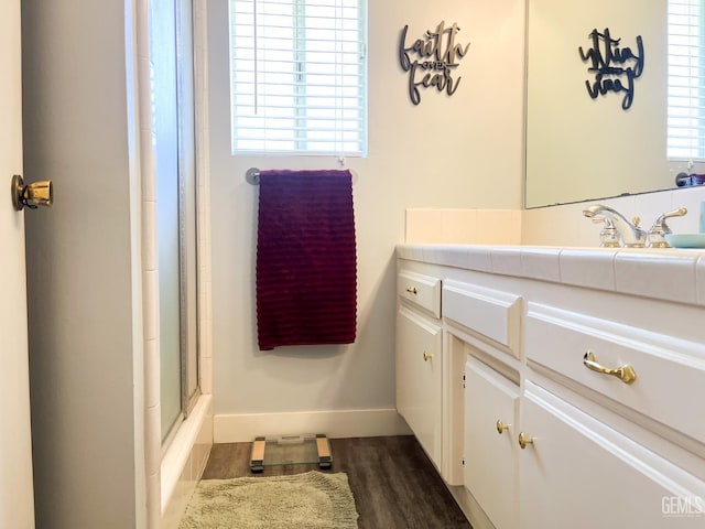 5421 Demaret Ave, Bakersfield, CA 93309 - bathroom with vanity, a shower with door, and wood finished floors