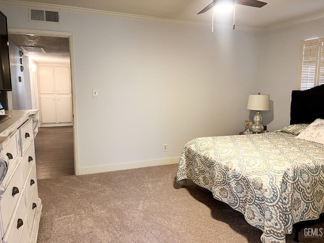 5421 Demaret Ave, Bakersfield, CA 93309 - bedroom with dark colored carpet, ornamental molding, and a ceiling fan