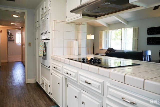 5421 Demaret Ave, Bakersfield, CA 93309 - kitchen with tile countertops, white appliances, white cabinets, tasteful backsplash, and dark wood-type flooring