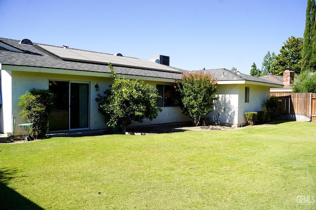 5421 Demaret Ave, Bakersfield, CA 93309 - rear view of property with stucco siding, solar panels, and a shingled roof