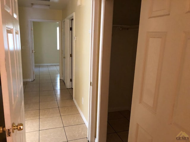 hallway with light tile patterned floors