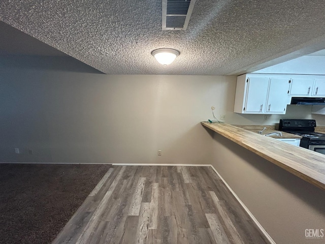 2626 Cleo Ct Unit 20, Bakersfield, CA 93306 - unfurnished dining area featuring dark wood-type flooring and a textured ceiling