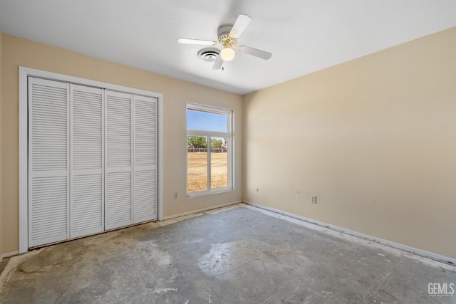 unfurnished bedroom with unfinished concrete flooring, baseboards, a closet, and ceiling fan