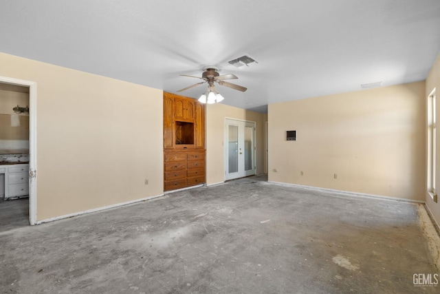 unfurnished bedroom with unfinished concrete flooring, french doors, ceiling fan, and baseboards