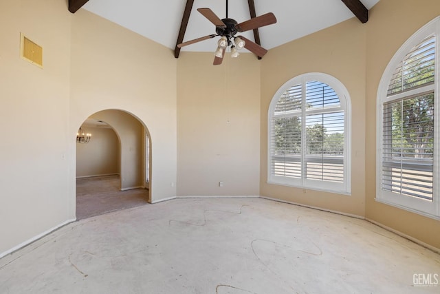 empty room with high vaulted ceiling, beam ceiling, ceiling fan, baseboards, and arched walkways