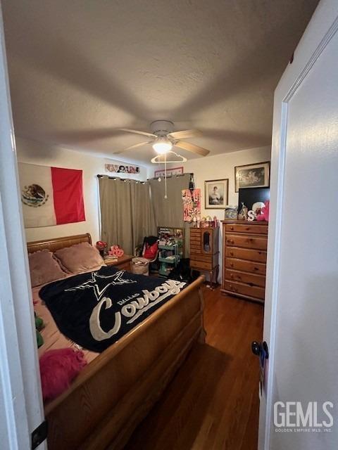 2320 Olympic Dr, Bakersfield, CA 93308 - bedroom featuring dark wood-style flooring and a ceiling fan