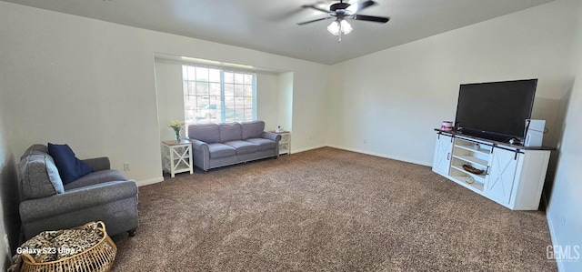 carpeted living room featuring ceiling fan and baseboards