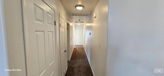 corridor with dark colored carpet and visible vents