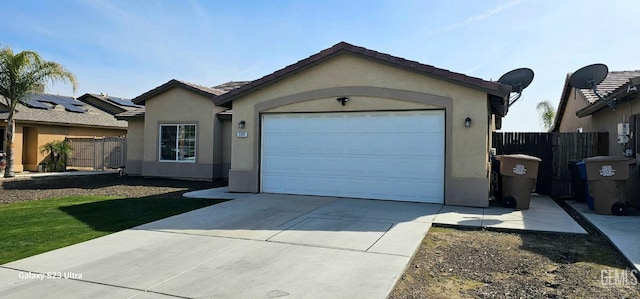 ranch-style house with fence, driveway, an attached garage, and stucco siding