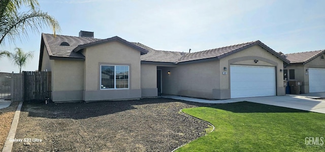 ranch-style house featuring a chimney, stucco siding, an attached garage, fence, and a tiled roof