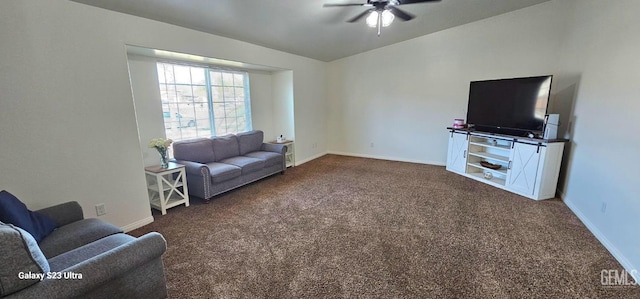 living area with dark carpet, baseboards, and ceiling fan