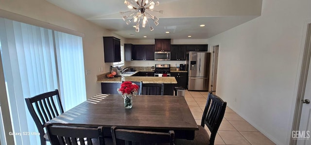 dining space featuring light tile patterned floors, a chandelier, and recessed lighting