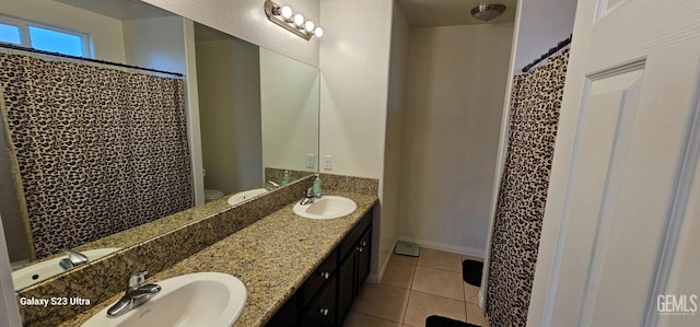 full bathroom with tile patterned flooring, a sink, toilet, and double vanity