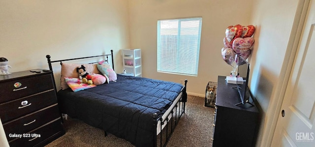 bedroom with dark colored carpet