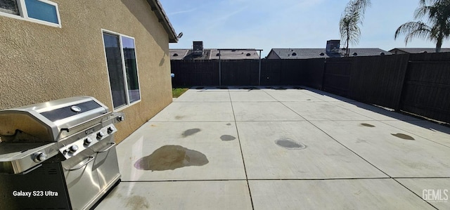 view of patio featuring a fenced backyard and a grill