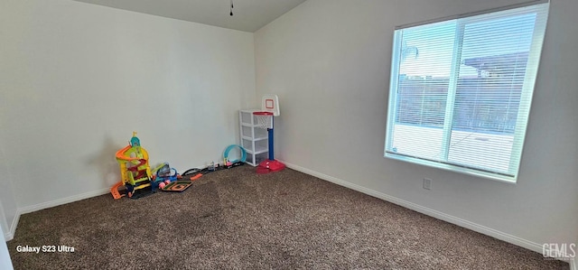 rec room with baseboards and carpet flooring