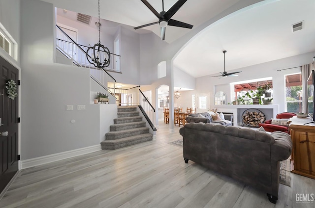 8315 Persimmon Dr, Bakersfield, CA 93311 - living area with a ceiling fan, a chandelier, arched walkways, stairway, and light wood-type flooring