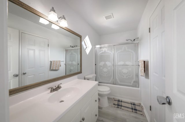 8315 Persimmon Dr, Bakersfield, CA 93311 - full bath featuring vanity, combined bath / shower with glass door, and wood finished floors