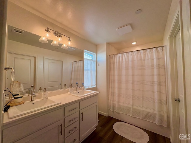 7303 Sepulveda Ct, Bakersfield, CA 93313 - bathroom with double vanity, wood finished floors, and shower / bath combo