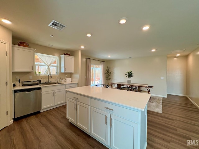 7303 Sepulveda Ct, Bakersfield, CA 93313 - kitchen featuring dishwasher, dark wood finished floors, white cabinets, a center island, and recessed lighting