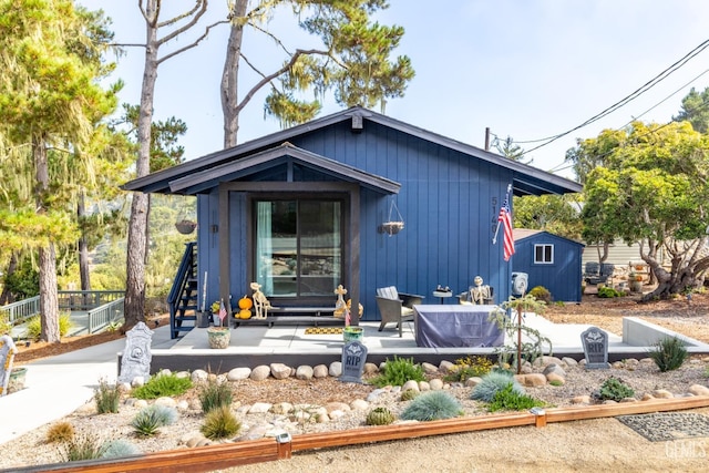 view of front of home featuring a storage unit