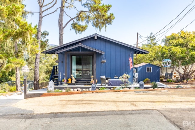 view of front of house with a storage shed