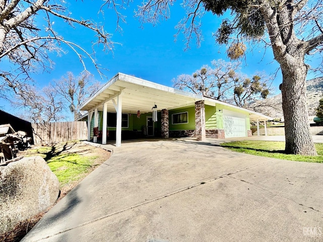 view of front of property with driveway and fence