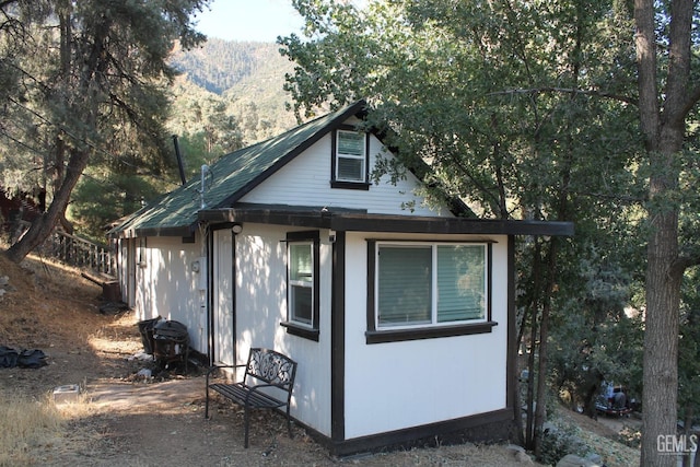 view of property exterior with a mountain view