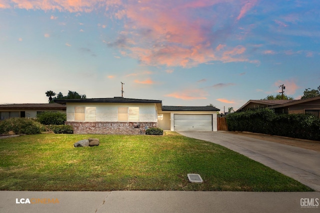 view of front facade with concrete driveway, an attached garage, stucco siding, stone siding, and a front yard