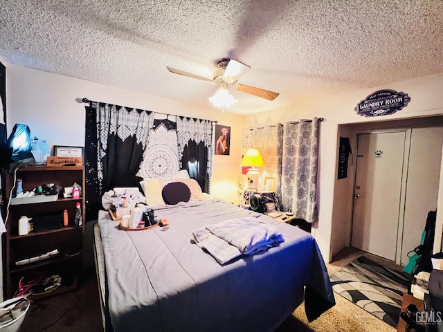 carpeted bedroom featuring a textured ceiling and ceiling fan