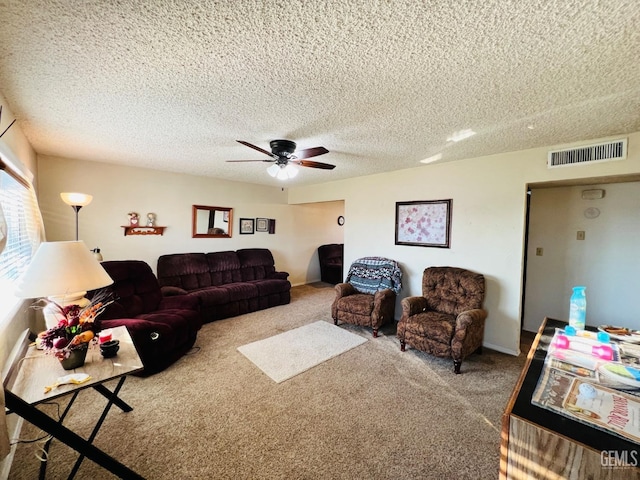 carpeted living room with a textured ceiling and ceiling fan