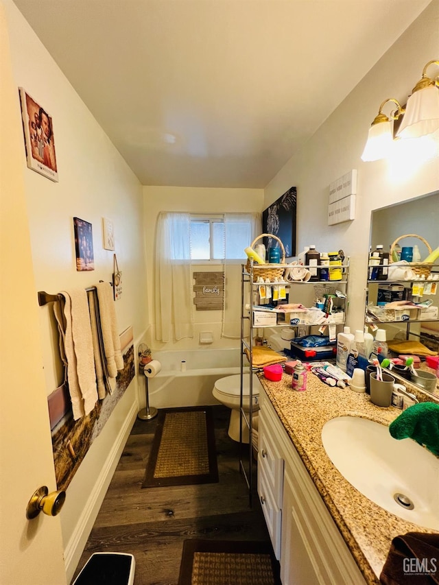 full bathroom with vanity, hardwood / wood-style flooring, shower / tub combination, and toilet