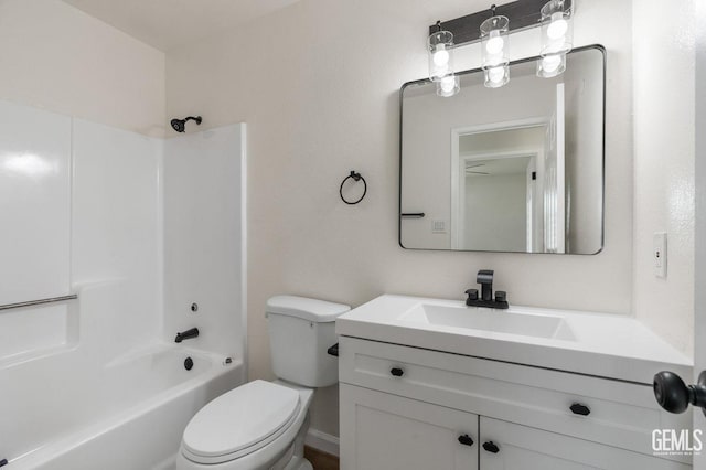 bathroom featuring toilet, vanity, and bathing tub / shower combination