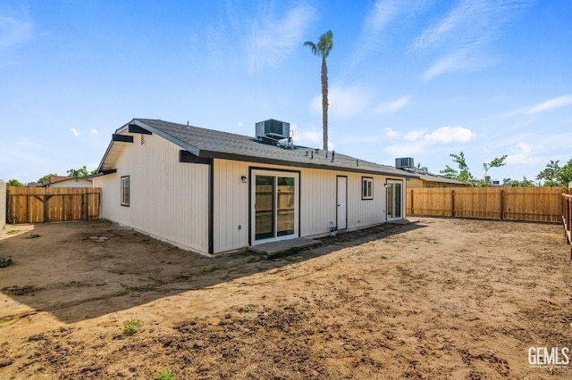 rear view of house featuring a fenced backyard and central AC unit