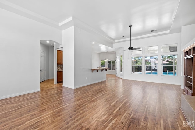 4207 Crystal Lake Dr, Bakersfield, CA 93313 - unfurnished living room featuring ceiling fan, wood finished floors, and arched walkways
