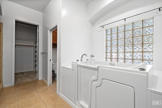 4207 Crystal Lake Dr, Bakersfield, CA 93313 - laundry room featuring light tile patterned floors and light carpet