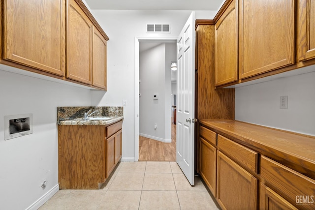 4207 Crystal Lake Dr, Bakersfield, CA 93313 - laundry area featuring hookup for a washing machine, cabinet space, and light tile patterned floors