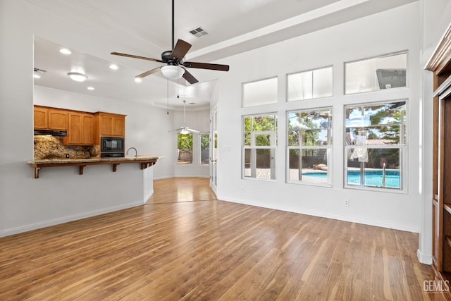 4207 Crystal Lake Dr, Bakersfield, CA 93313 - unfurnished living room with light wood finished floors, ceiling fan, and recessed lighting