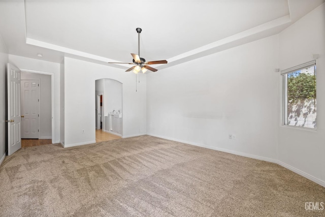 4207 Crystal Lake Dr, Bakersfield, CA 93313 - unfurnished bedroom with carpet, arched walkways, and a raised ceiling
