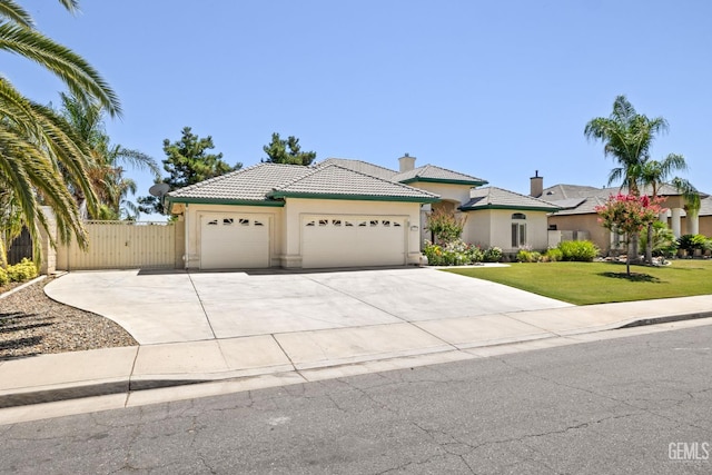 4207 Crystal Lake Dr, Bakersfield, CA 93313 - view of front of house featuring stucco siding, a garage, a tile roof, and concrete driveway