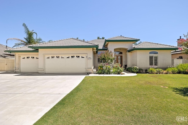 4207 Crystal Lake Dr, Bakersfield, CA 93313 - mediterranean / spanish-style home featuring an attached garage, stucco siding, concrete driveway, and a tiled roof