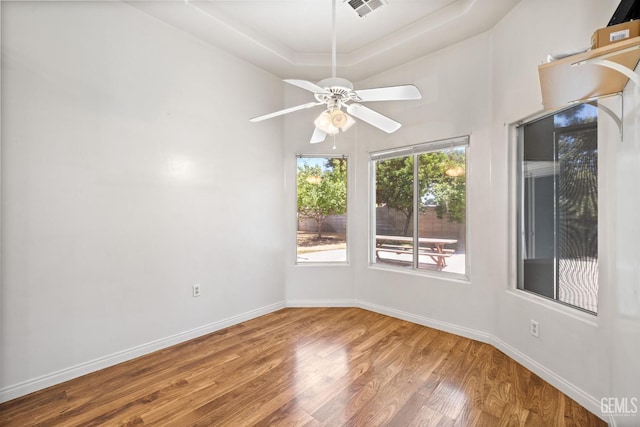 4207 Crystal Lake Dr, Bakersfield, CA 93313 - empty room with wood finished floors, a ceiling fan, and a tray ceiling