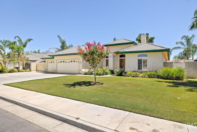 4207 Crystal Lake Dr, Bakersfield, CA 93313 - mediterranean / spanish-style house with a chimney, stucco siding, a tile roof, an attached garage, and driveway