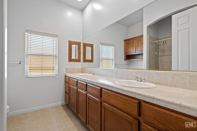 4207 Crystal Lake Dr, Bakersfield, CA 93313 - full bathroom featuring double vanity, tiled shower, and tile patterned flooring