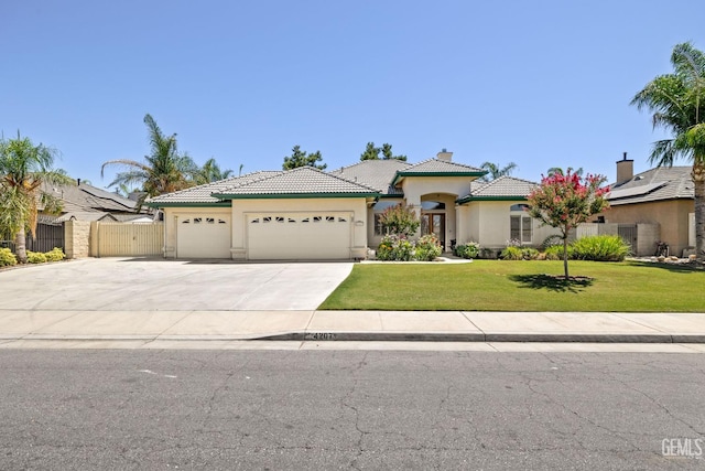 4207 Crystal Lake Dr, Bakersfield, CA 93313 - mediterranean / spanish-style home featuring an attached garage, stucco siding, concrete driveway, a chimney, and a tile roof