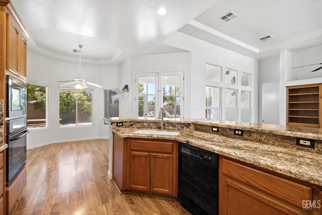 4207 Crystal Lake Dr, Bakersfield, CA 93313 - kitchen featuring black appliances, a raised ceiling, a ceiling fan, and light wood finished floors