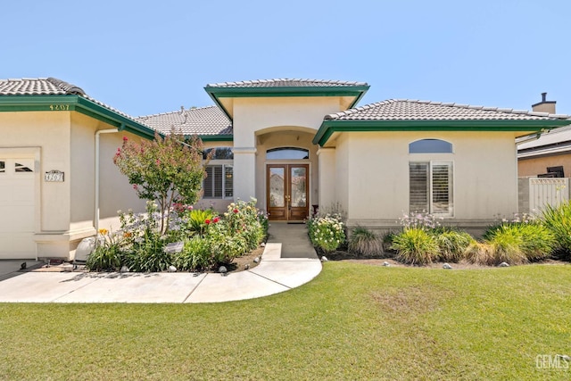 4207 Crystal Lake Dr, Bakersfield, CA 93313 - mediterranean / spanish home featuring french doors, a front yard, a tile roof, and an attached garage